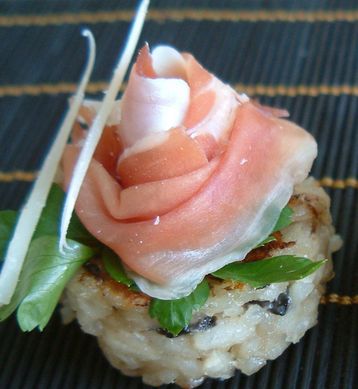 Wild Mushroom Risotto Cakes Topped with Prosciutto and Parmesan and Drizzled with Truffle Oil.